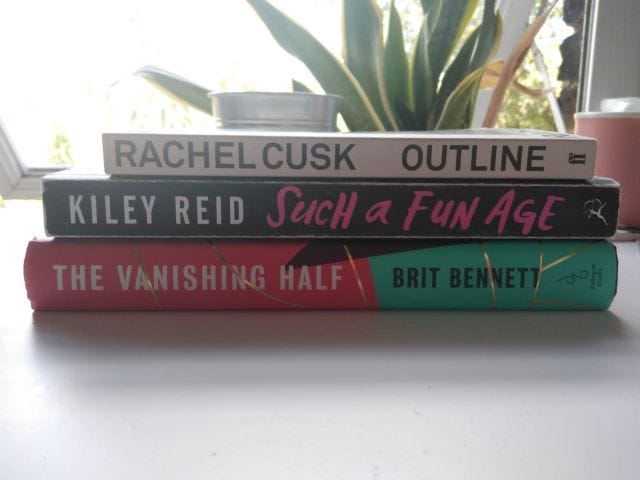 Three books stacked on top of each other (from bottom to top): Brit Bennett's The Vanishing Half, Kiley Reid's Such A Fun Age and Rachel Cusk's Outline