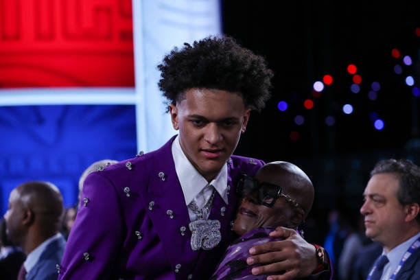 Paolo Banchero hugs with his a family member after being selected number one overall by the Orlando Magic during the 2022 NBA Draft on June 23, 2022...