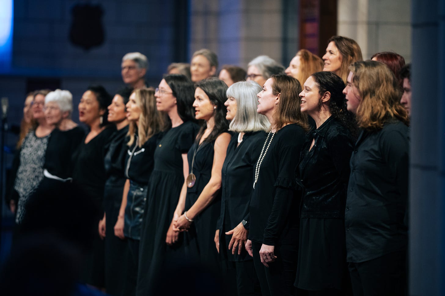 The Stimmung Choir singing all dressed in black