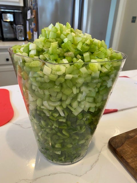 A large pitcher is filled over the brim with chopped celery and green bell peppers.