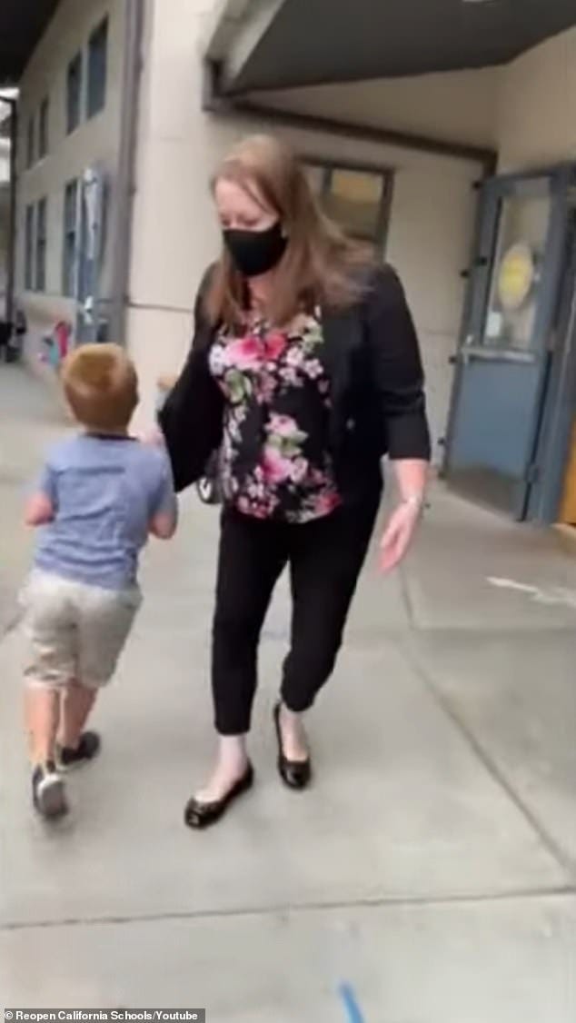 Michelle Williams, principal of Theuerkauf Elementary School in Mountain View, California, is seen on Thursday turning Shawn's four-year-old son away from class