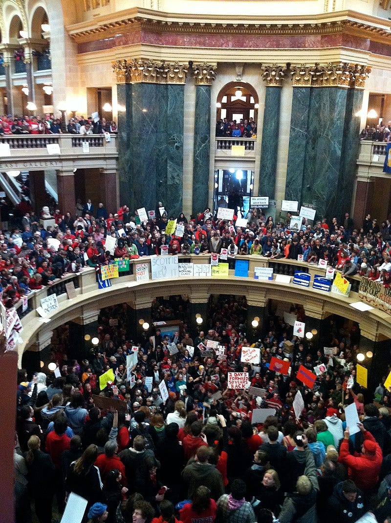 Overhead view of hundreds of people wearing red for the teachers' unions, protesting against Walker's bill.