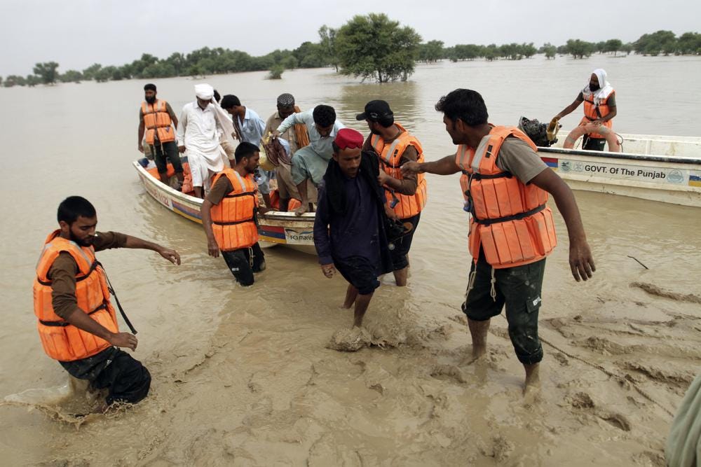 Army troops evacuate people from a flood-hit area in Rajanpur, district of Punjab, Pakistan, Saturday, Aug. 27, 2022. Officials say flash floods triggered by heavy monsoon rains across much of Pakistan have killed nearly 1,000 people and displaced thousands more since mid-June. (AP Photo/Asim Tanveer)