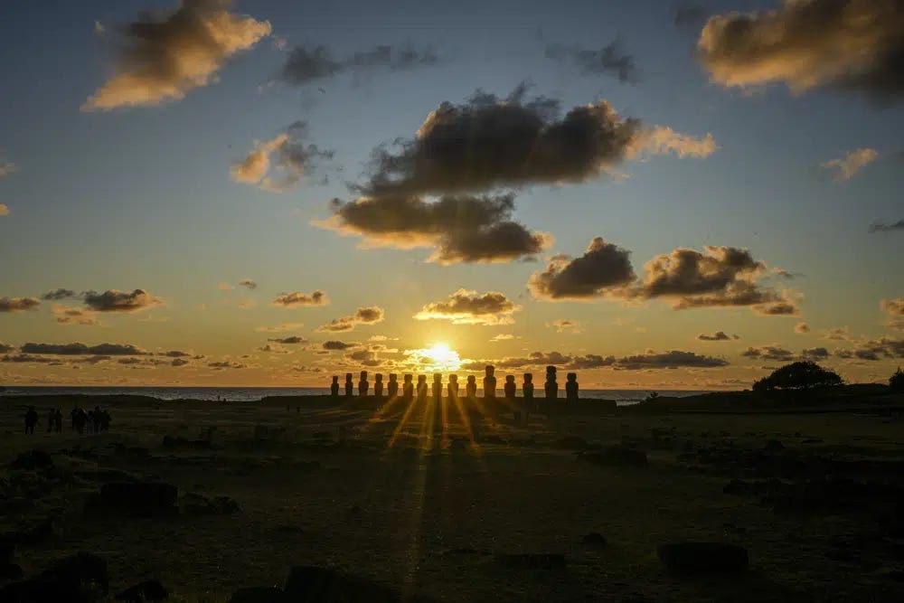 The sun rises behind a line of moai statues on Ahu Tongariki, Rapa Nui, or Easter Island, Chile, Saturday, Nov. 26, 2022. Each monolithic human figure carved centuries ago by this remote Pacific island's Rapanui people represents an ancestor. (AP Photo/Esteban Felix)