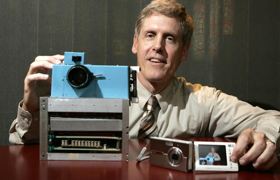 Steven J. Sasson shows his prototype digital camera he built in 1975 (AP Photo/David Duprey)