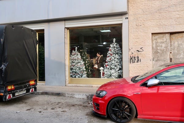 Woman buying Christmas tree in Ramallah.jpg