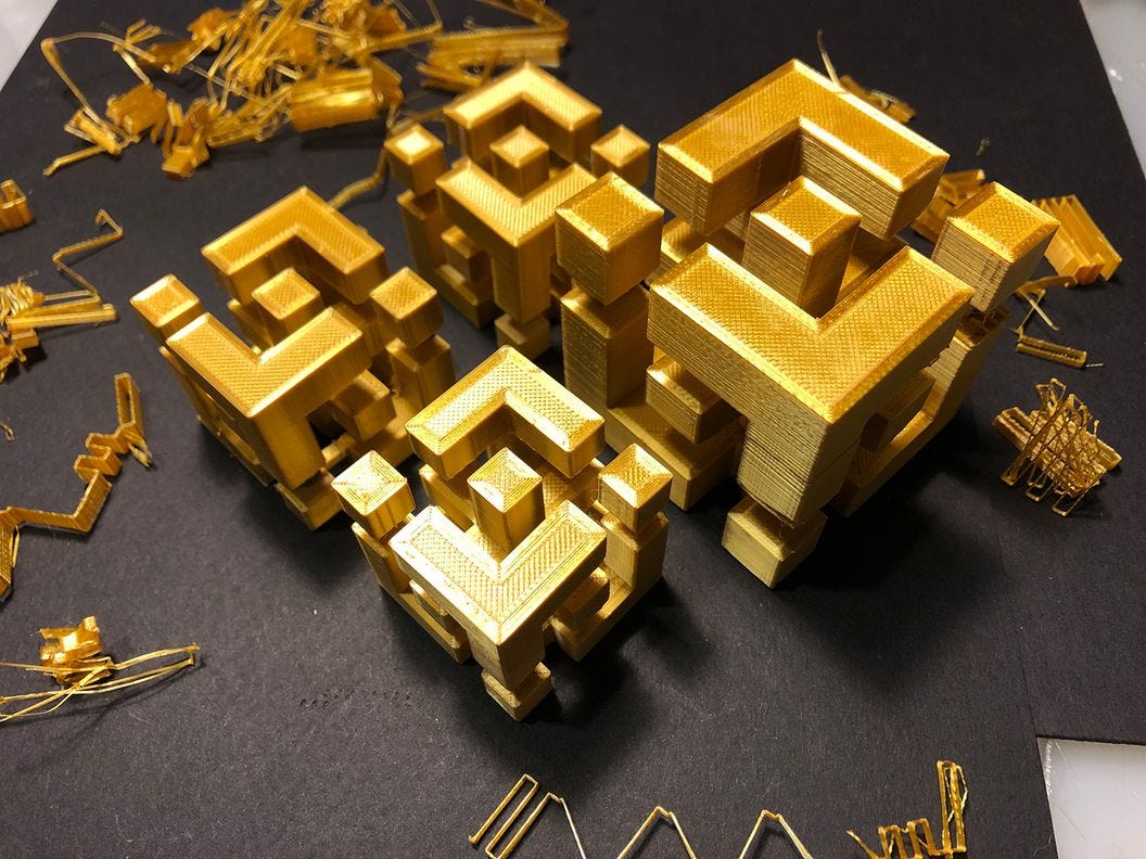 CDCROP: Binance logo 3D printed in gold (Rob Mitchell/CoinDesk)