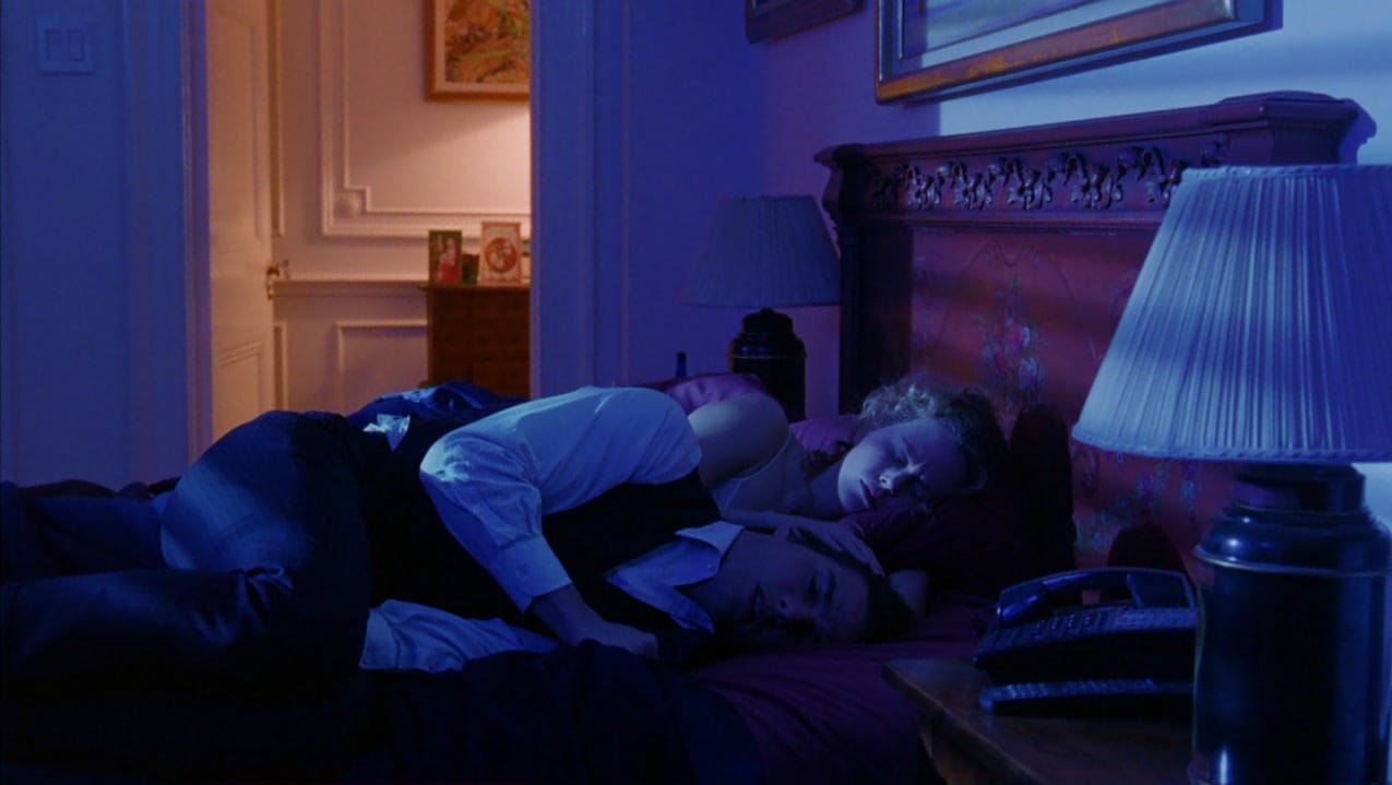 Film still from Eyes Wide Shut. Nicole Kidman and Tom Cruise are fast asleep in their bedroom.