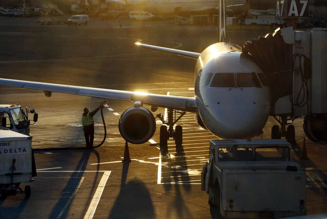 A worker fuels a passenger jet at Boston Logan International Airport. Scientists have found a new way to quickly convert plastic into jet fuel. (AP Photo/Bill Sikes)