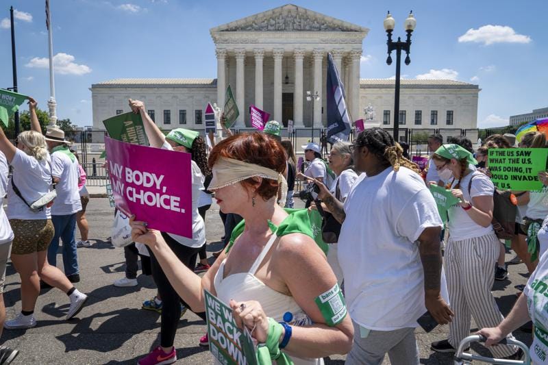Mahayana Landowne, of Brooklyn, N.Y., wears a "Lady Justice" costume as she marches past the Supreme Court during a protest for abortion-rights, Thursday, June 30, 2022, in Washington. (AP Photo/Jacquelyn Martin)
