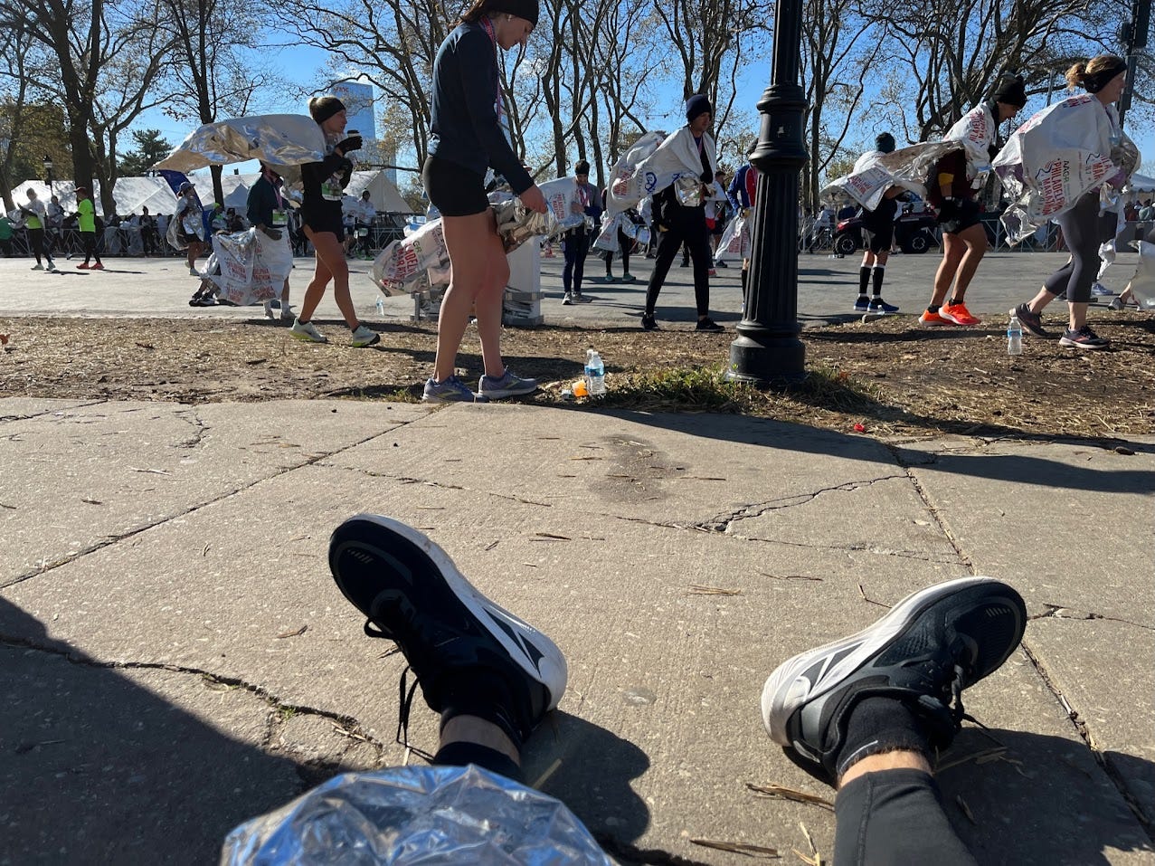 Runners after the Philadelphia marathon wearing space blankets