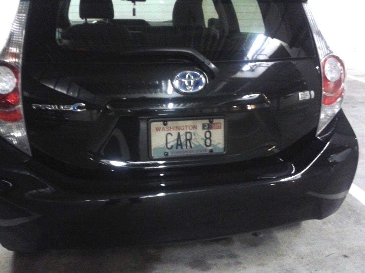 A toyota Prius C from the back showing the license plate "CAR 8"