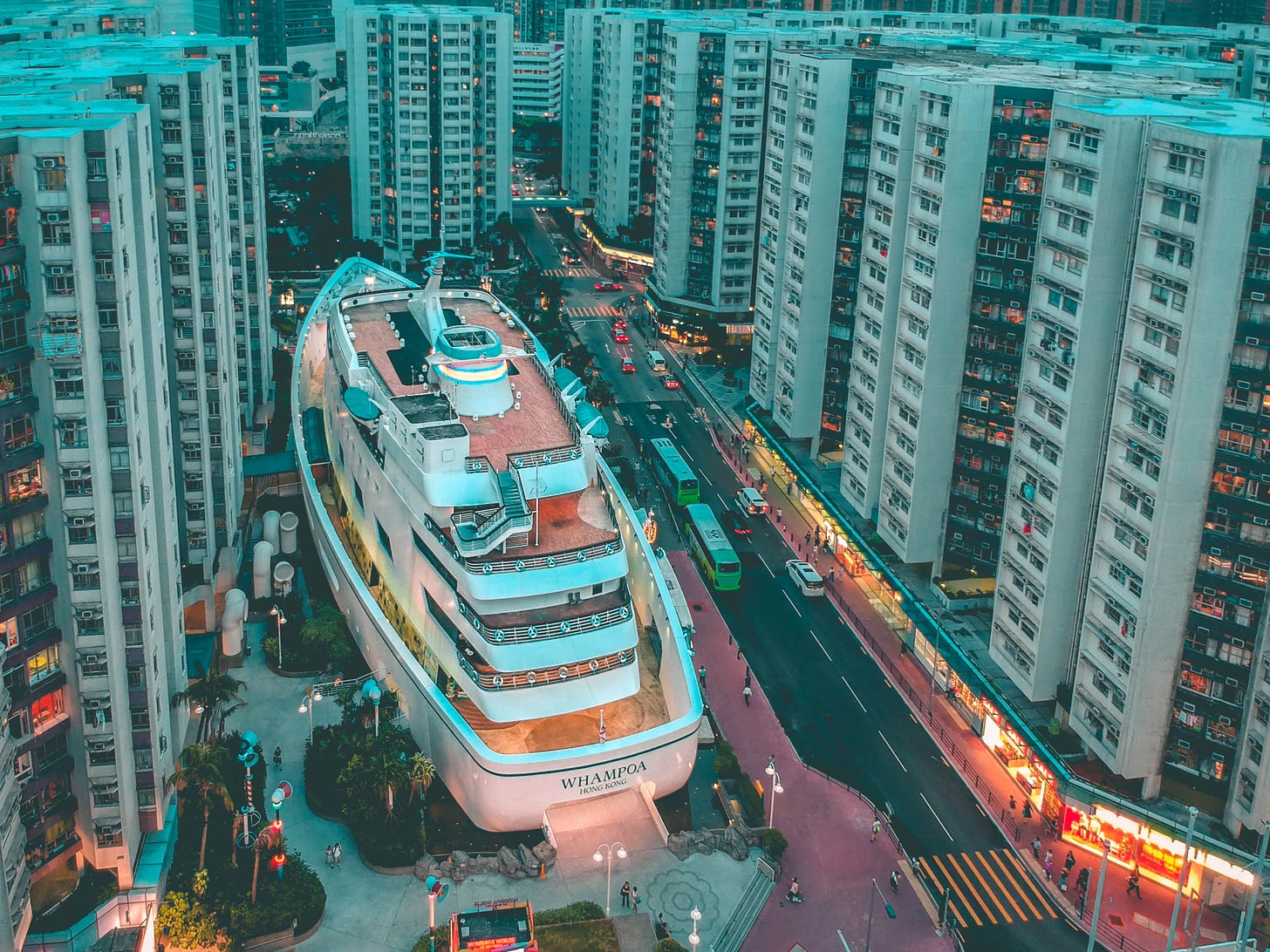 white boat building surrounded with high-rise buildings photo