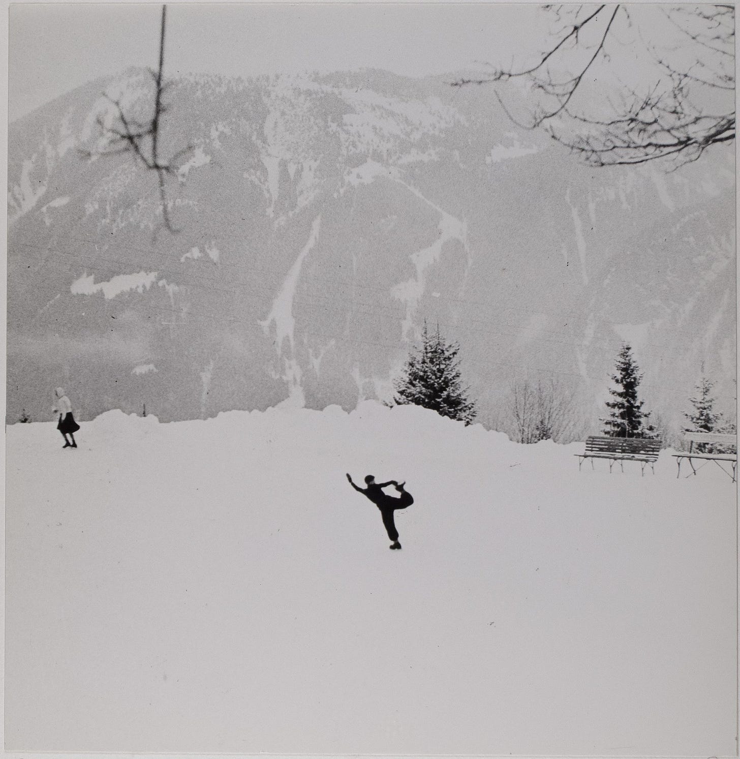 Two skaters on an outdoor rink in front of mountains in Arosa, Switzerland, in 1946