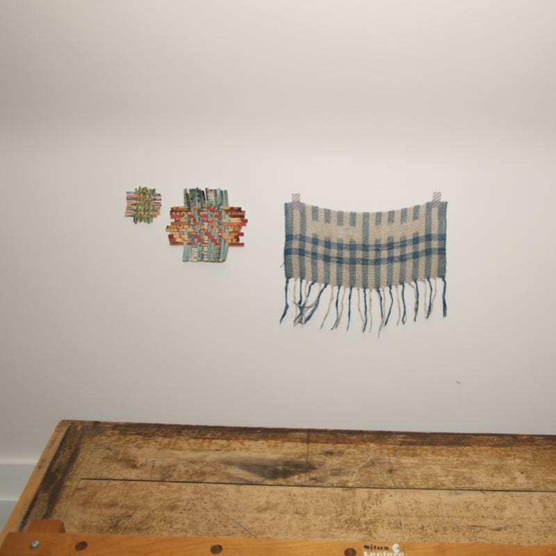 one textile and two paper weavings on the wall
