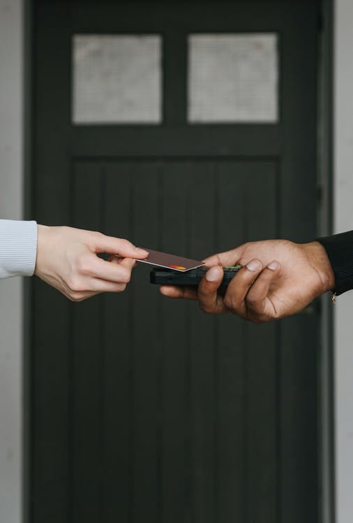 Free A Person Swiping a Card on a Payment Terminal Stock Photo