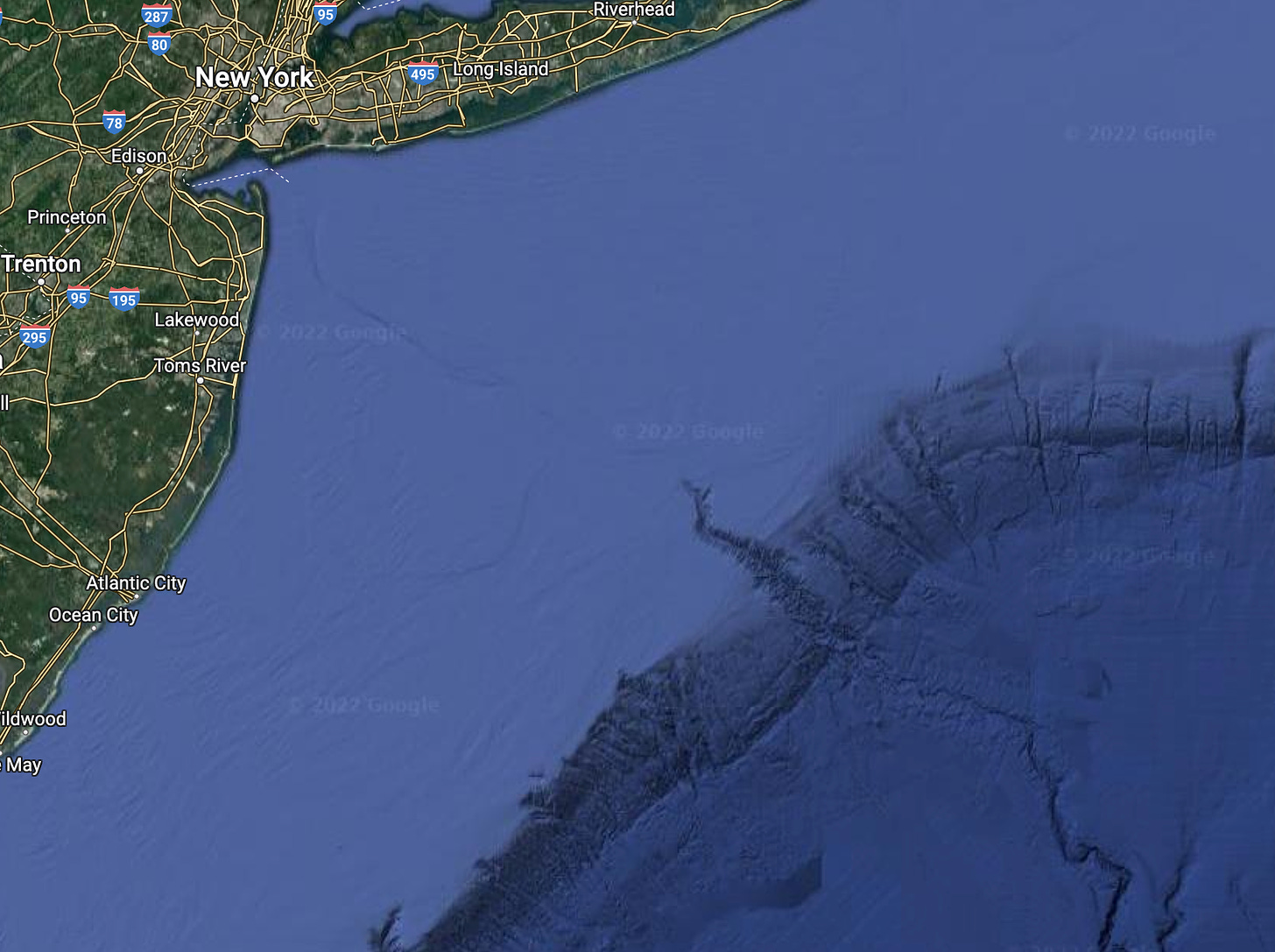 a screenshot from google maps showing new jersey and long island at the top right, then the faint indent of the hudson shelf valley going down and to hte right until the center of the image where a deeper cut in the continental shelf appears, spanning all the way to the bottom right of the image