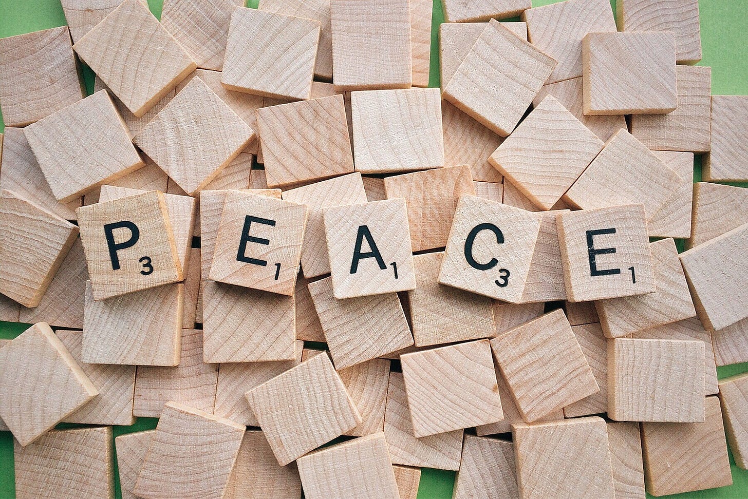Scrabble pieces spelling out the word PEACE
