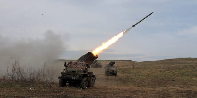 A Ukrainian multiple rocket launcher shells a Russian troop position near Luhansk in the Donbas region on Sunday.