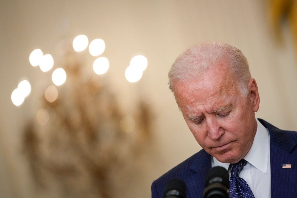 WASHINGTON, DC - AUGUST 26: U.S. President Joe Biden bows his head in a moment of silence as he speaks about the situation in Kabul, Afghanistan from the East Room of the White House on August 26, 2021 in Washington, DC. At least 12 American service members were killed on Thursday by suicide bomb attacks near the Hamid Karzai International Airport in Kabul, Afghanistan. (Photo by Drew Angerer/Getty Images)