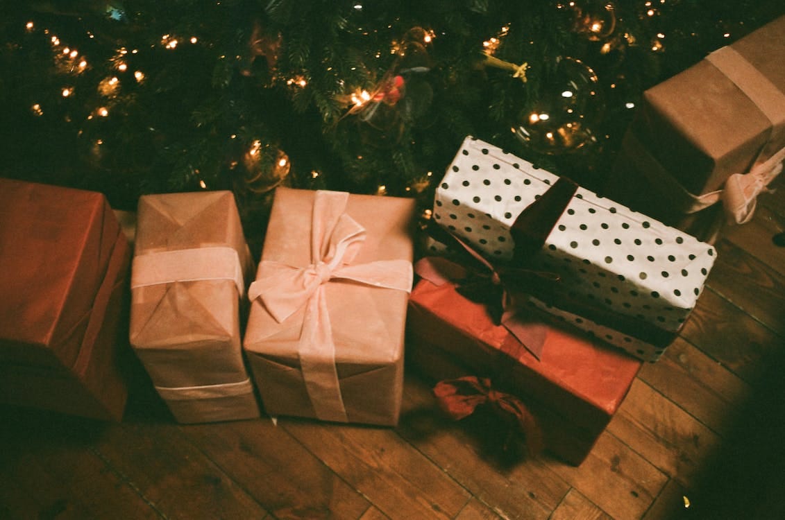 Free Assorted Gift Boxes on Floor Near Christmas Tree Stock Photo