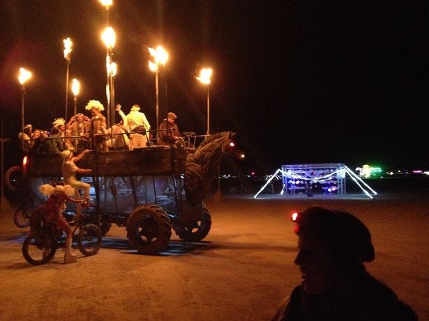 People ride art cars around the playa at all hours of the day and night at Burning Man 2014