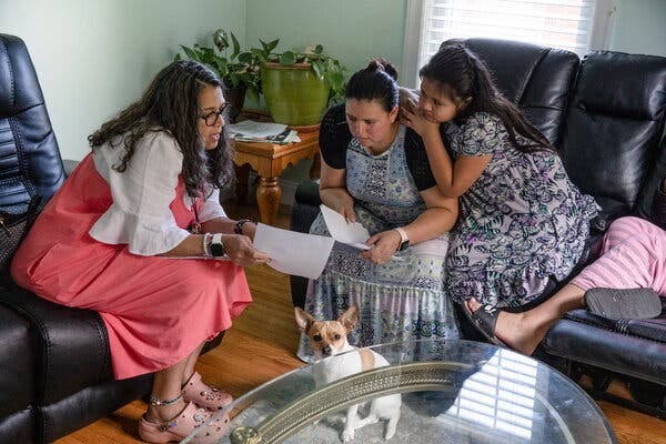 Ms. Ocasio, left, during a home visit with Blanca Ortega, center, and her daughter, Julissa Jadan Ortega, right.