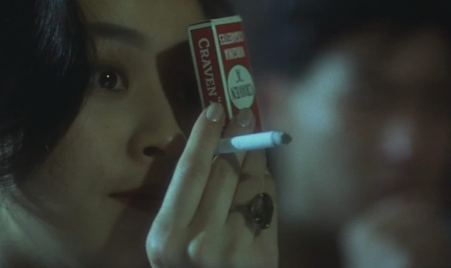 Carina Lau holding a cigarette and a deck of cards in “Days of Being Wild” (1990)