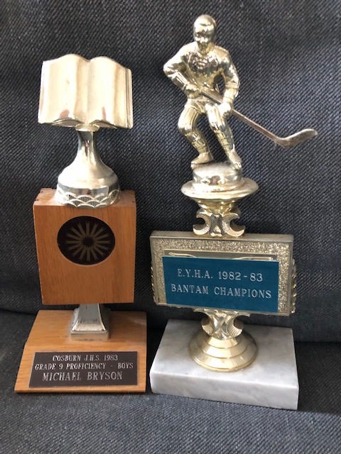 Image of two trophies from 1983, one academic and home hockey
