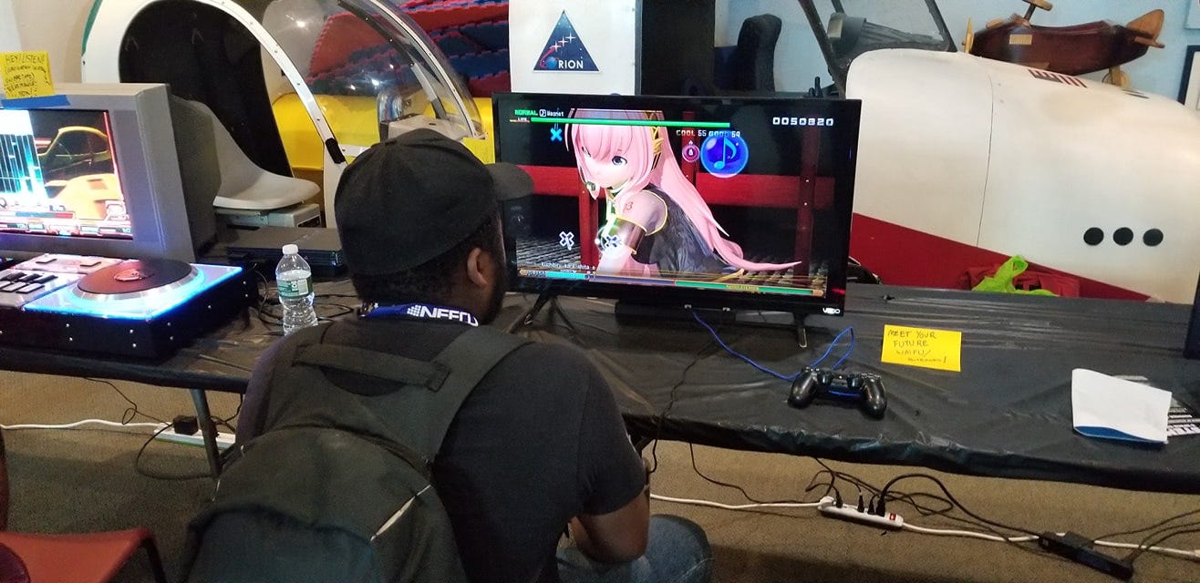 A picture of Sylverstone Khandr playing a Hatsune Miku rhythm game on PlayStation 4.