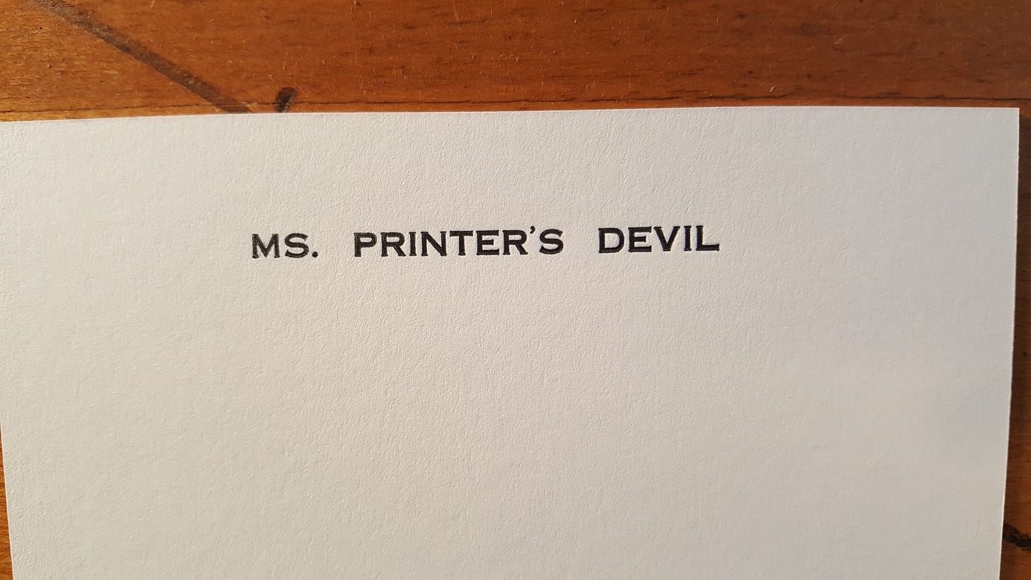Printed card that reads "MS. PRINTER'S DEVIL" in black type on white paper