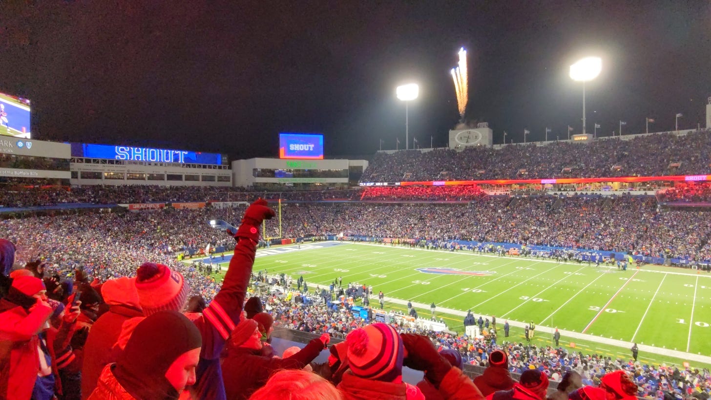 The view from Section 208 at Highmark Stadium during the Bills wild card win over the Patriots on January 15 2022. Fireworks are going off in the background. It's night and the lights of the stadium accentuate the incredible atmosphere under the night sky.