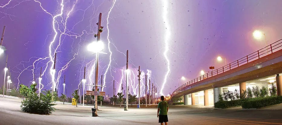 Lightning striking at different points near a road