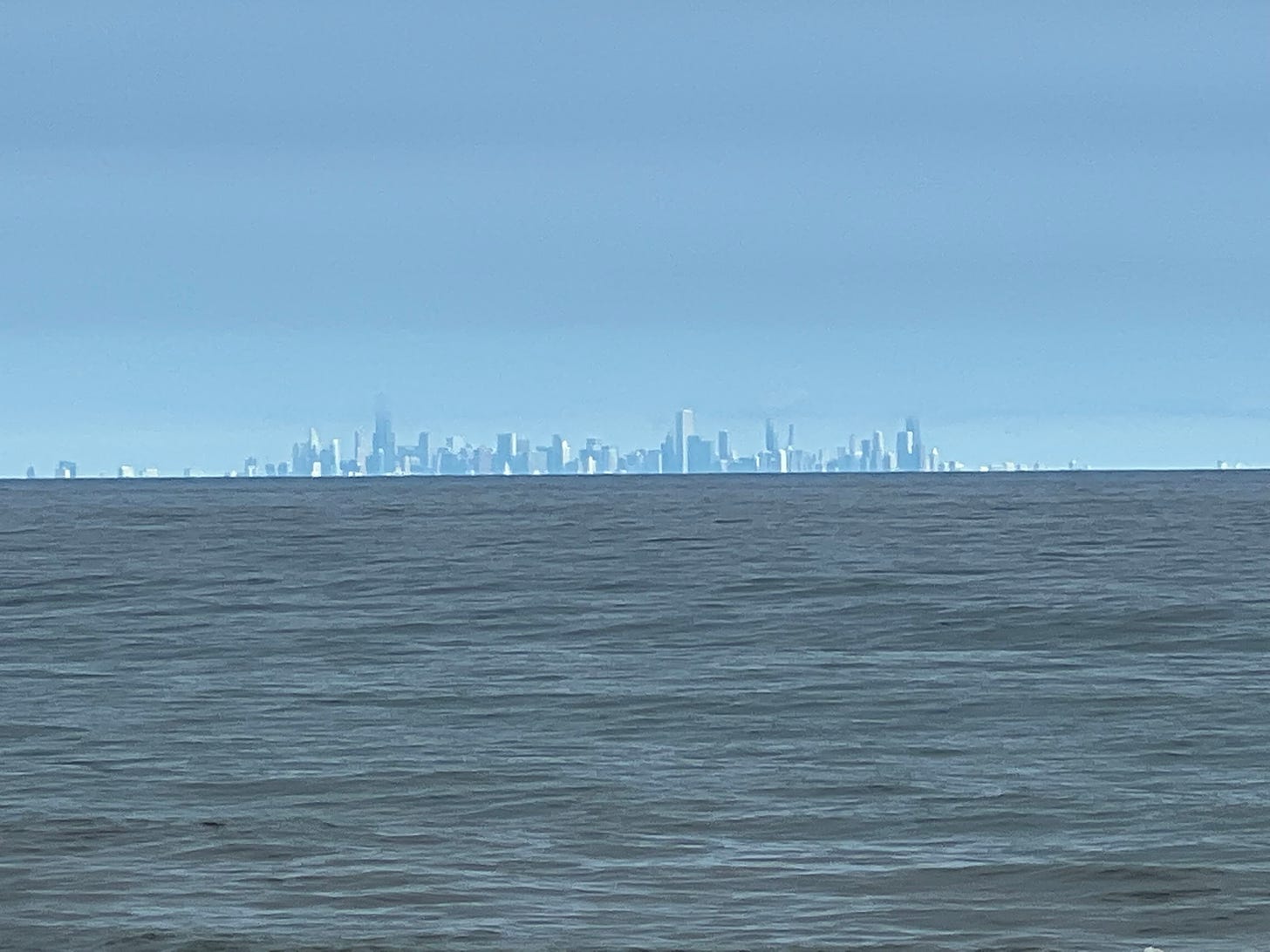 Chicago's skyline on a clear day, as seen from Miller Beach, Indiana, Lake Michigan in foreground