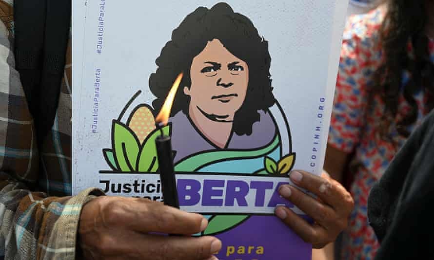 A member of Indigenous rights organisation Copinh holds a candle while waiting for the sentencing of Roberto David Castillo, the businessman found guilty of collaborating in the murder of environmental defender Berta Cáceres.