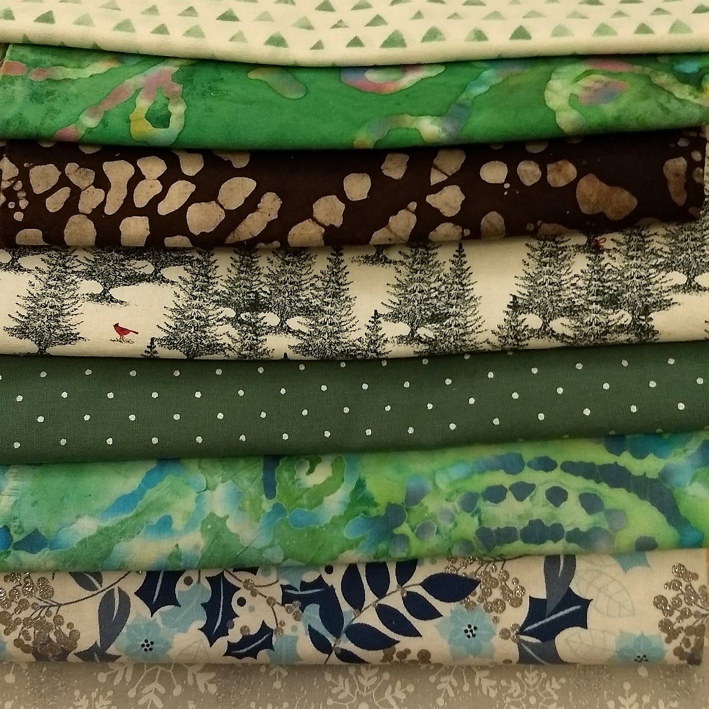 Photo of eight winter-themed fabrics