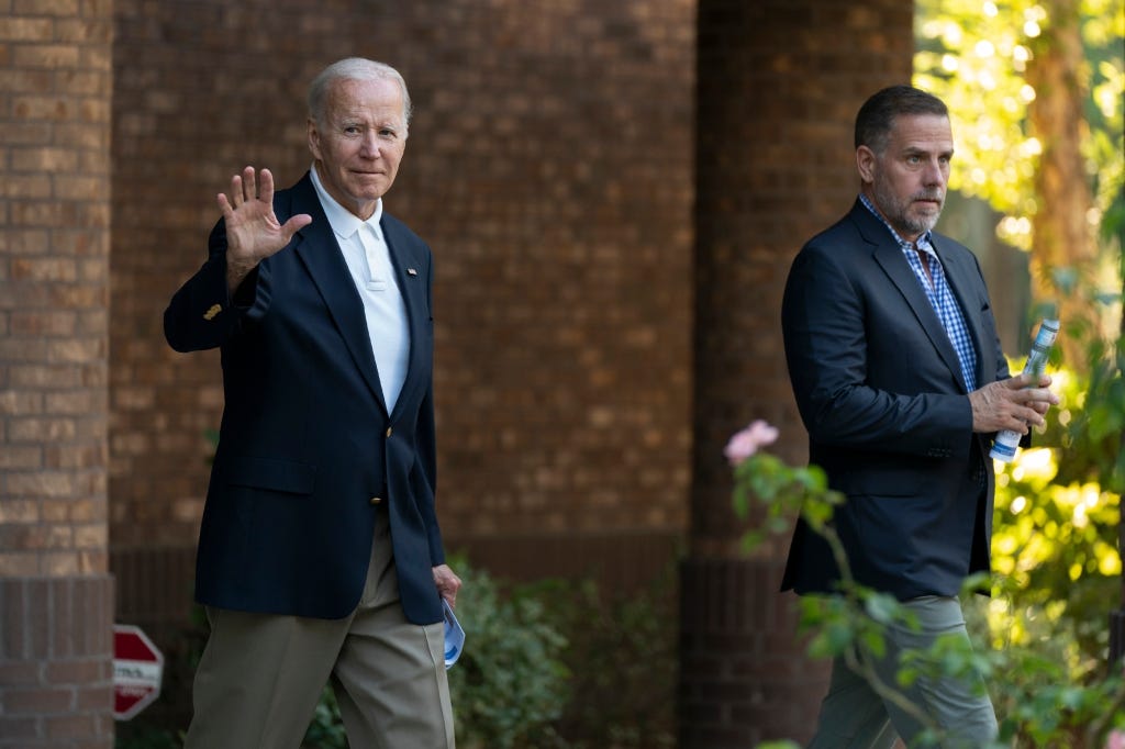 President Joe Biden with his son Hunter Biden waves as they leave Holy Spirit Catholic Church.