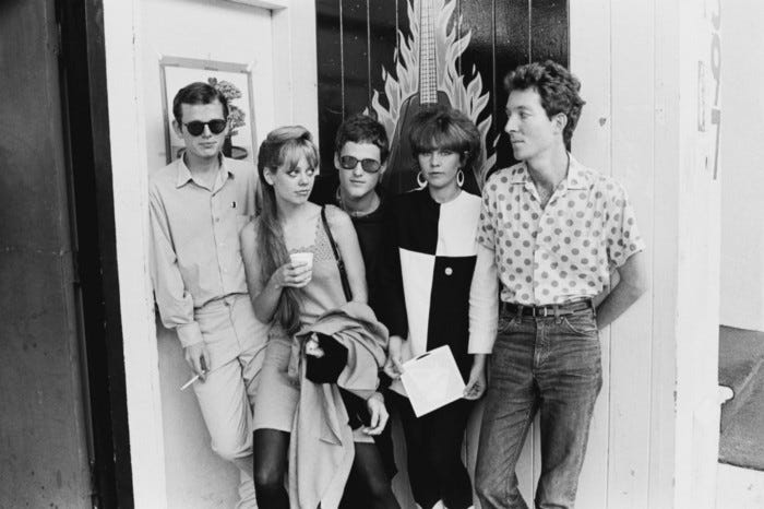 A black and white photo of the band The B-52's.
