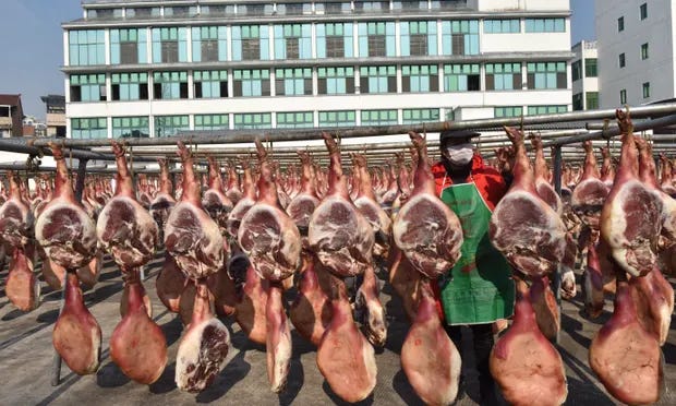 Rack of hams drying at an outdoor Chinese market. Rack of hams drying at an outdoor Chinese market.