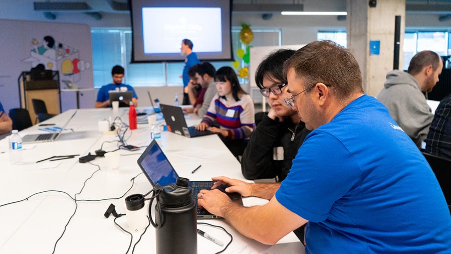 A participant working closely with a facilitator at GDCR Toronto 2019.