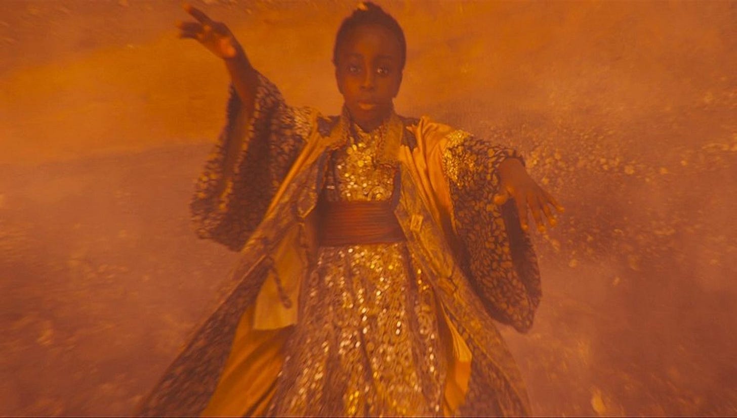 This image shows the first Timeless Child (played by an unknown child actress) falling toward a Gallifreyan beach. The young girl flails her arms as she plummets toward the ground. This image shows the first Timeless Child (played by an unknown child actress) falling toward a Gallifreyan beach. The young girl flails her arms as she plummets toward the ground.