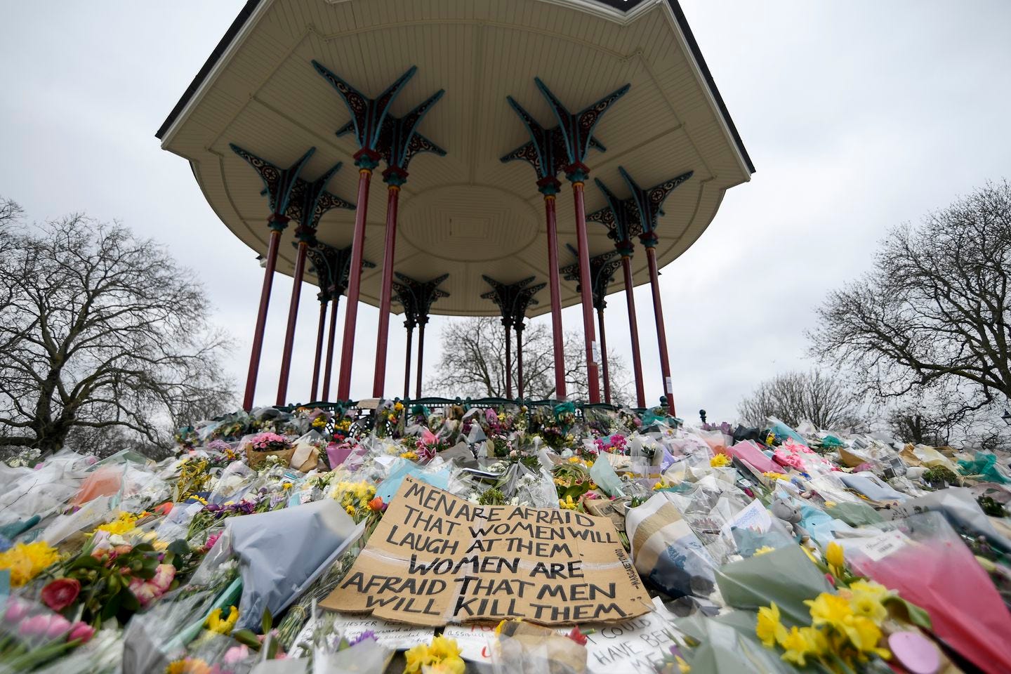 In this Saturday, March 20, 2021 file photo, floral tributes and messages are placed at the bandstand on Clapham Common in London in memory of Sarah Everard. A British police officer has pleaded guilty to murdering Everard, who was abducted as she walked home from a friend’s house in London.