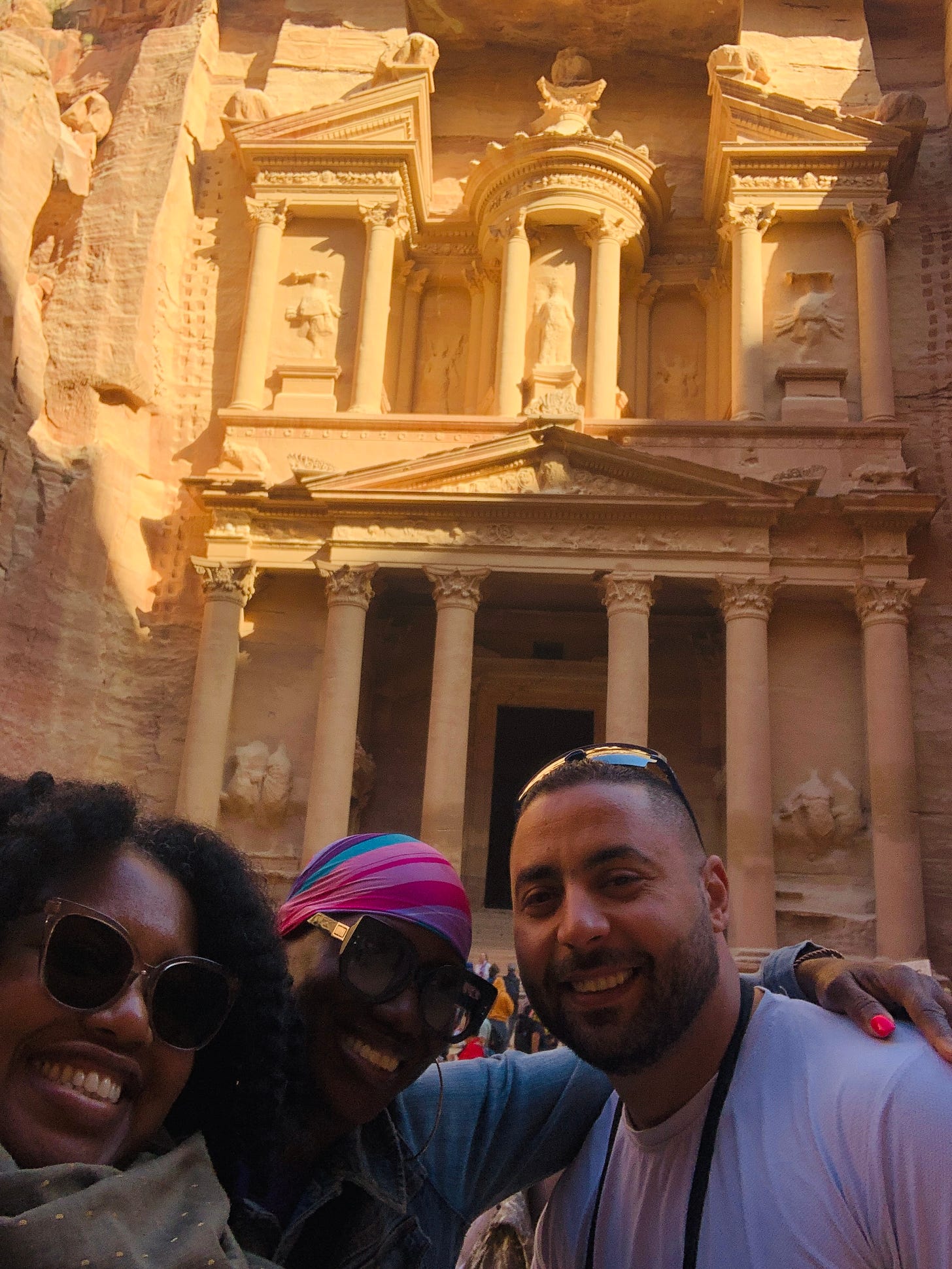Me, my cousin, and our guide, Abed, in front of the Treasury in Petra