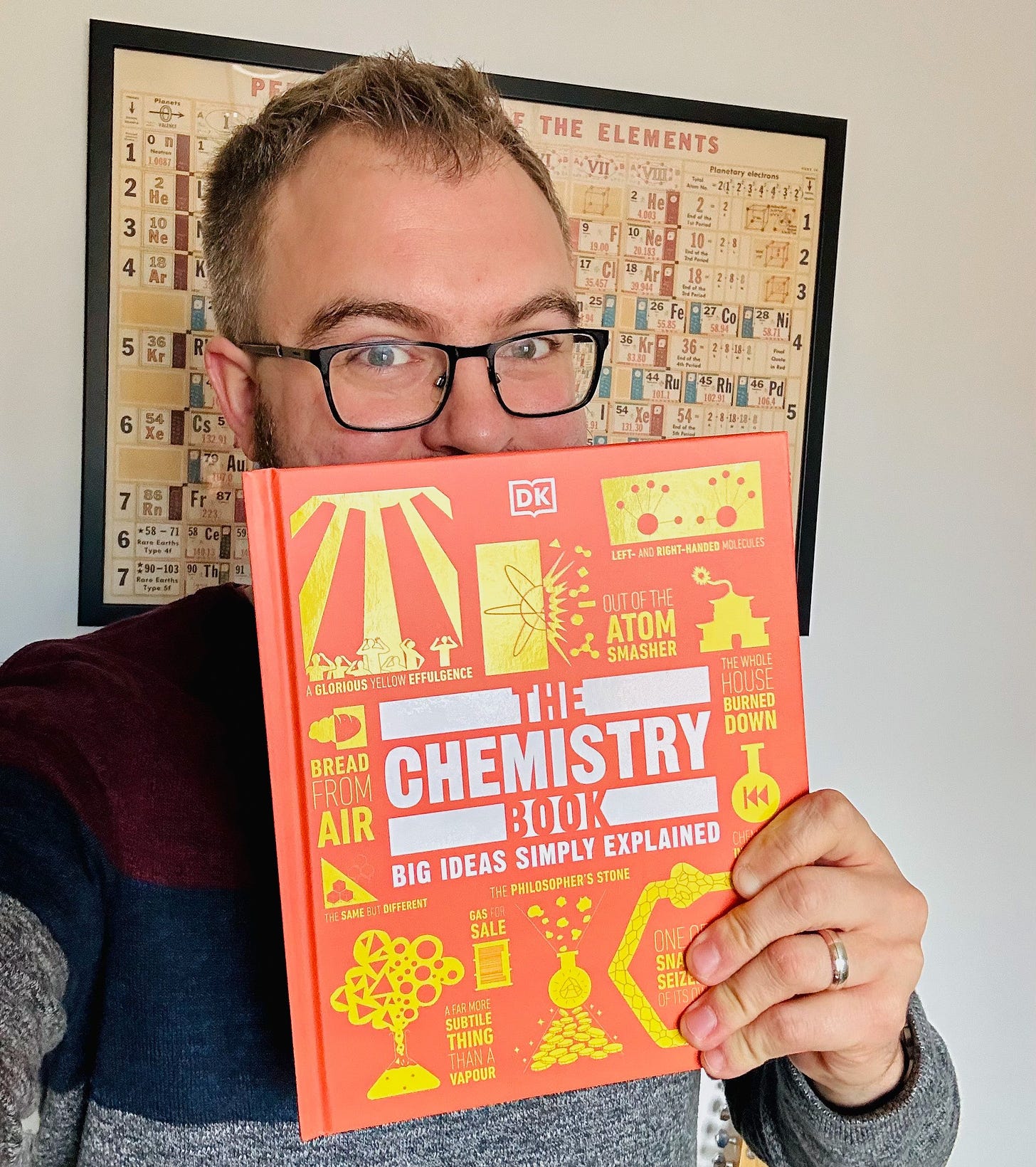 Photo of me holding up a book, “The Chemistry Book”