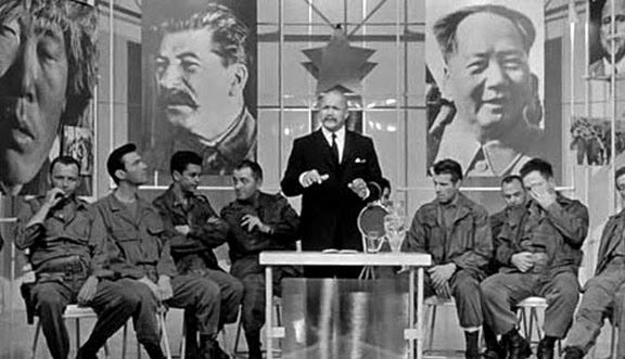 A screen grab from "The Manchurian Candidate," in which soldiers sit around a Lenin cosplayer