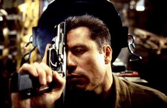John Travolta goes the "Head On. Apply directly to forehead" route in "Broken Arrow," John Woo's 1996 action-thriller distributed by 20th Century Fox.