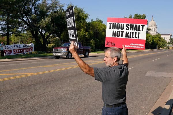 Ronnie Aebischer, an opponent of the death penalty who said that James Coddington was his cousin, protested on Thursday outside the governor’s mansion in Oklahoma City.