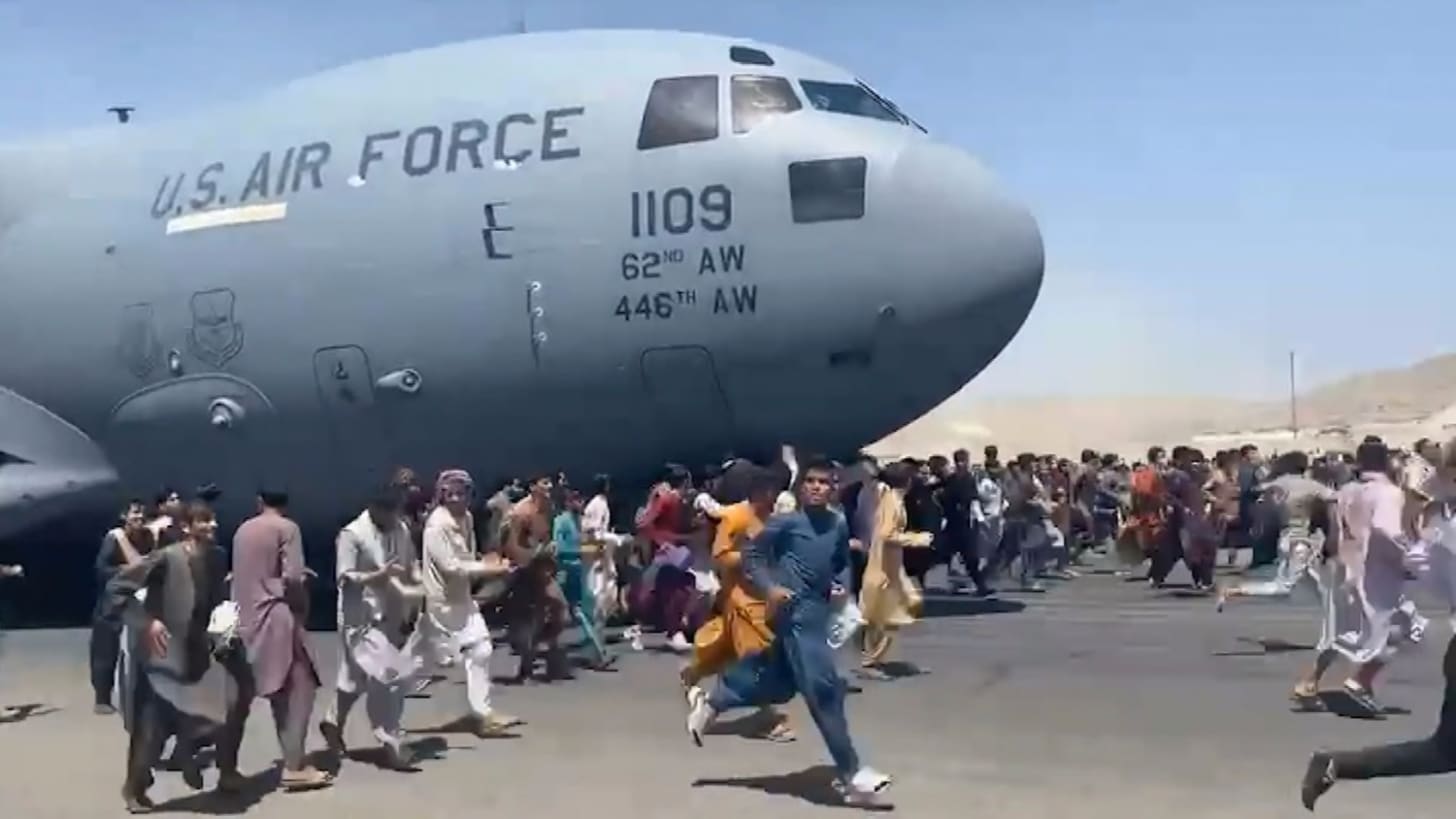 Body found in landing gear of U.S. plane people clung to as it left Kabul