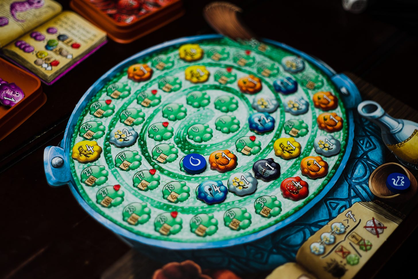 The board game Quacks of Quedlinburg being played. Many tokens are sitting on top of a cauldron board.