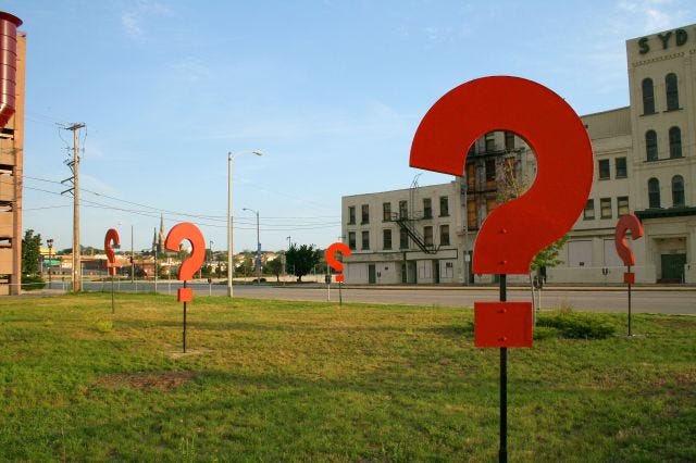 Question marks on a vacant plot